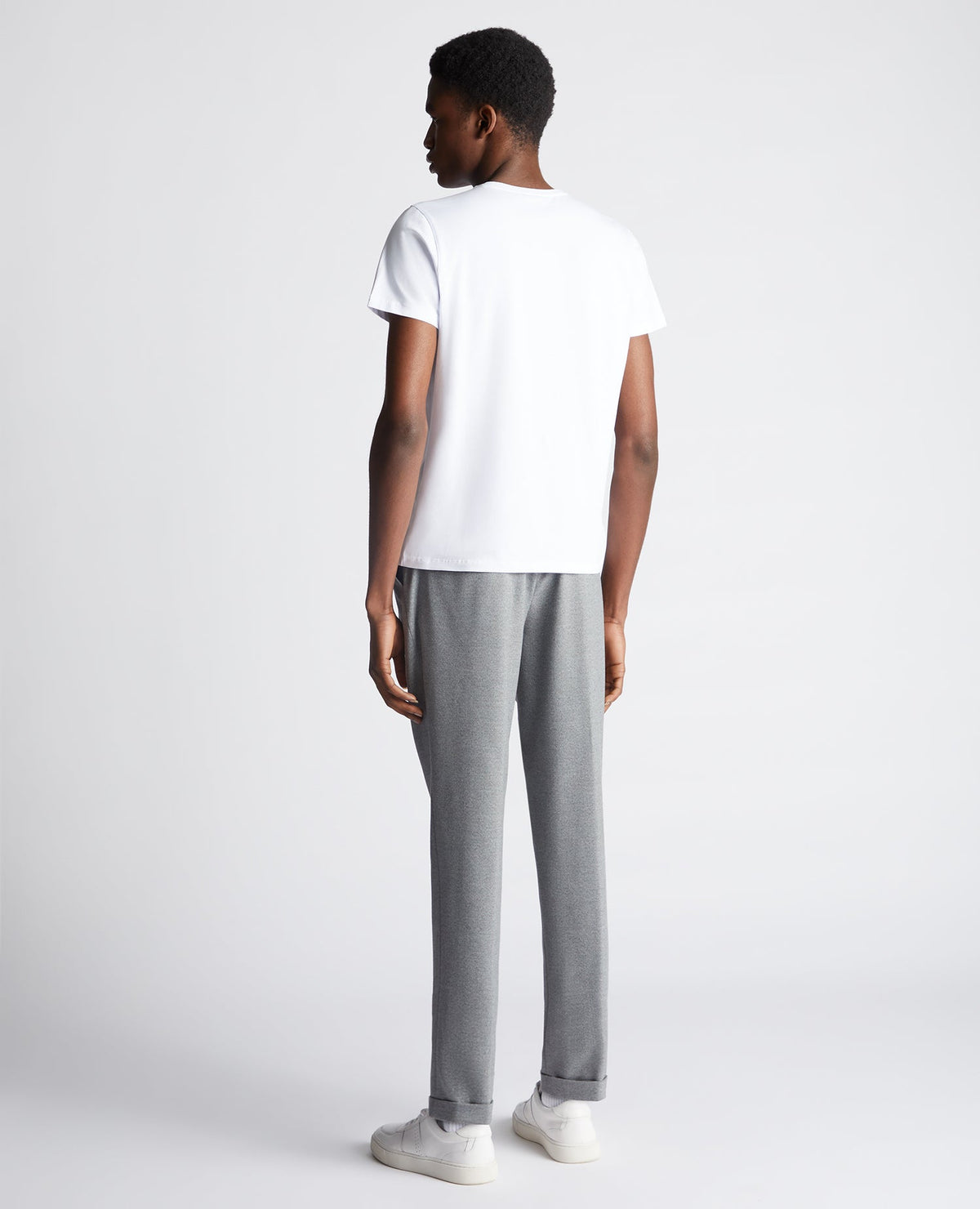 Man wearing a white Tapered Fit Cotton-Stretch T-Shirt