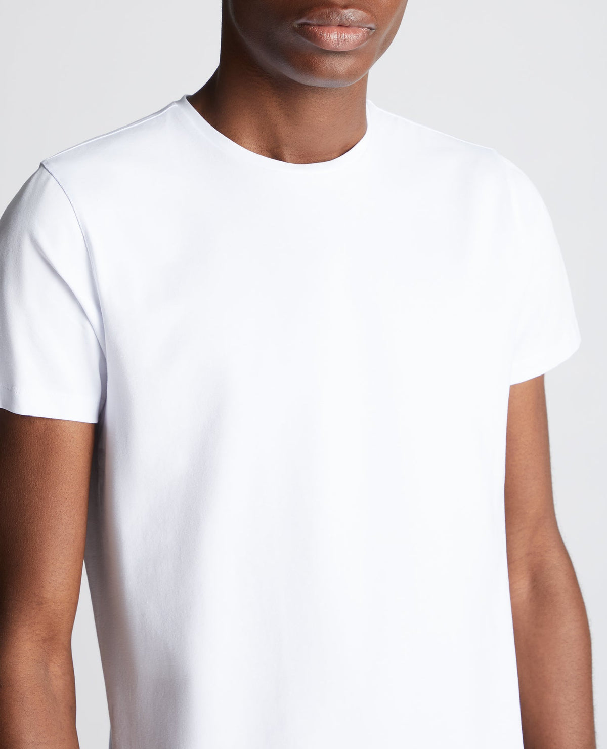 Man wearing a white Tapered Fit Cotton-Stretch T-Shirt