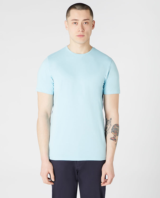Man wearing a blue Tapered Fit Cotton-Stretch T-Shirt
