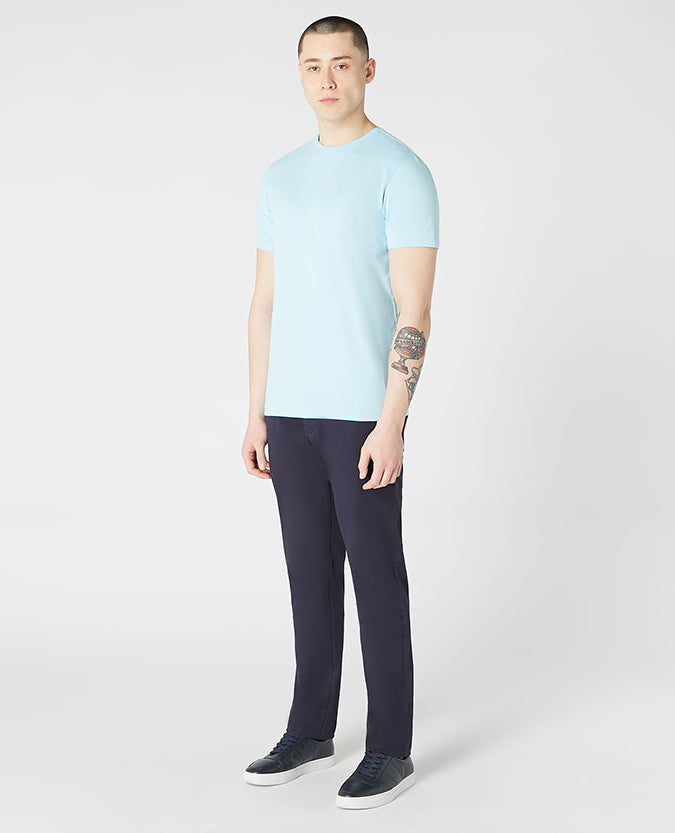 Man wearing a blue Tapered Fit Cotton-Stretch T-Shirt