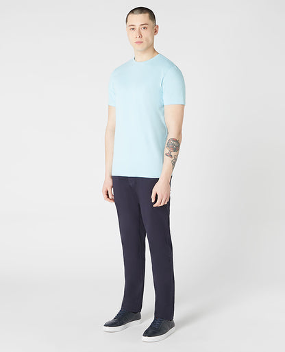 Man wearing a blue Tapered Fit Cotton-Stretch T-Shirt