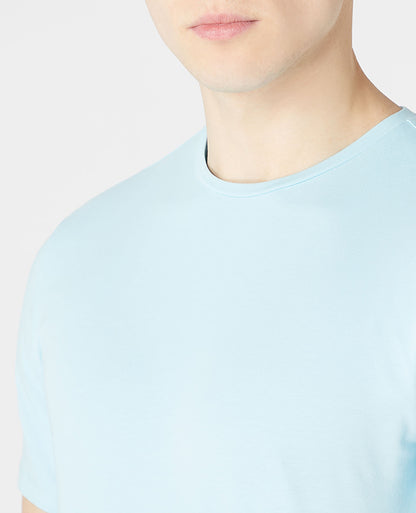 Man wearing a blue Tapered Fit Cotton-Stretch T-Shirt