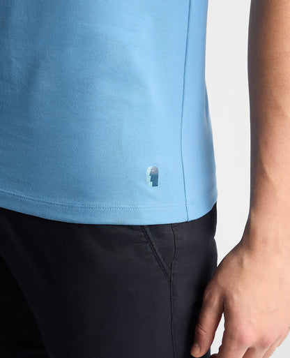 Man wearing a blue Tapered Fit Cotton-Stretch T-Shirt