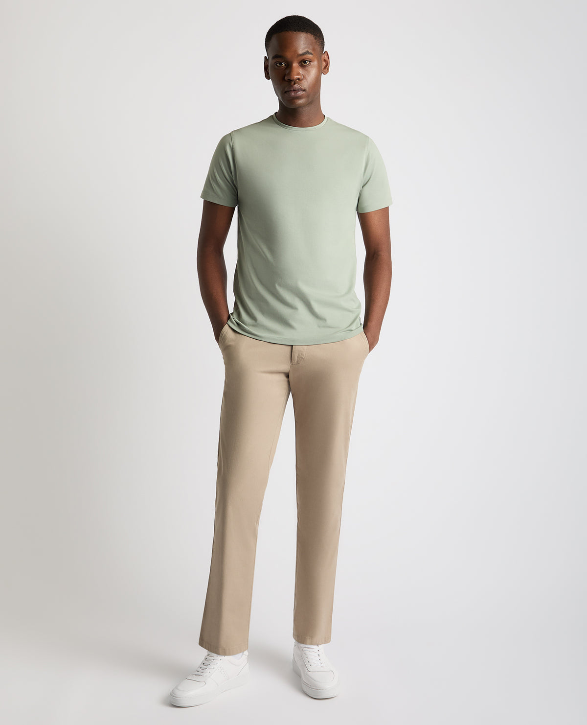 Man wearing a green Tapered Fit Cotton-Stretch T-Shirt