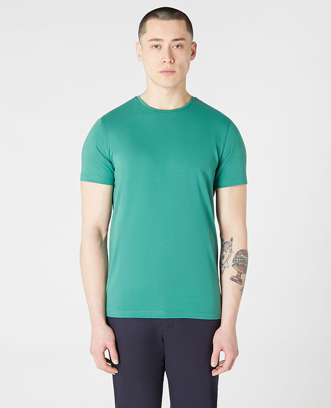 Man wearing a green Tapered Fit Cotton-Stretch T-Shirt