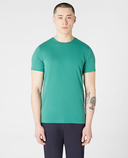 Man wearing a green Tapered Fit Cotton-Stretch T-Shirt