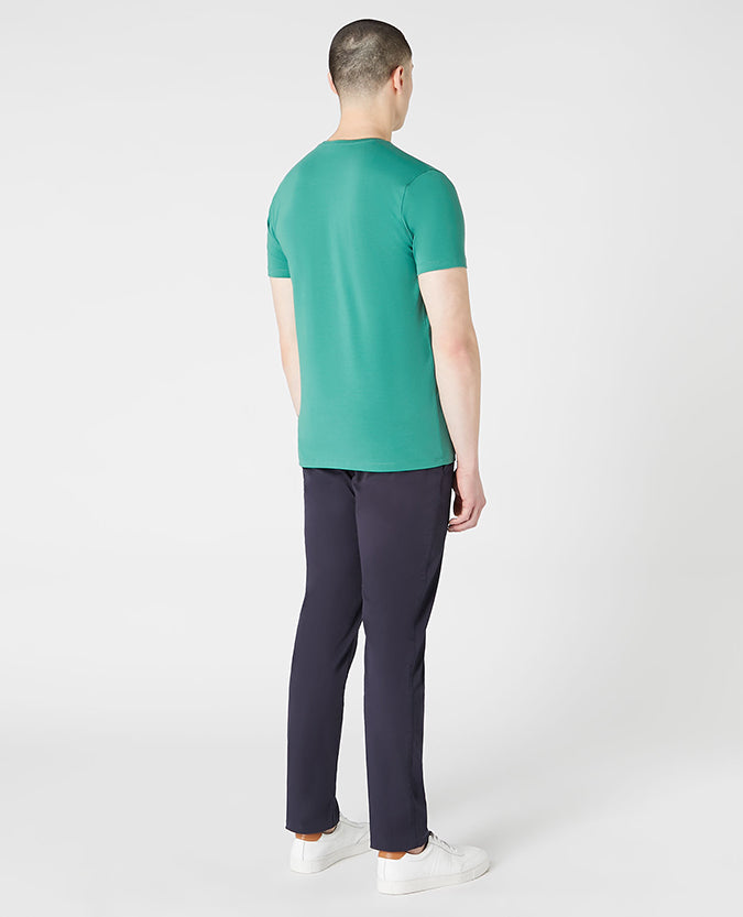 Man wearing a green Tapered Fit Cotton-Stretch T-Shirt