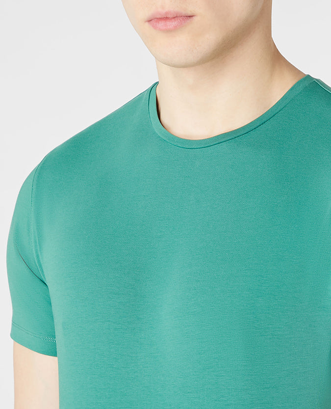 Man wearing a green Tapered Fit Cotton-Stretch T-Shirt
