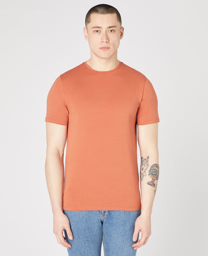 Man wearing a orange Tapered Fit Cotton-Stretch T-Shirt