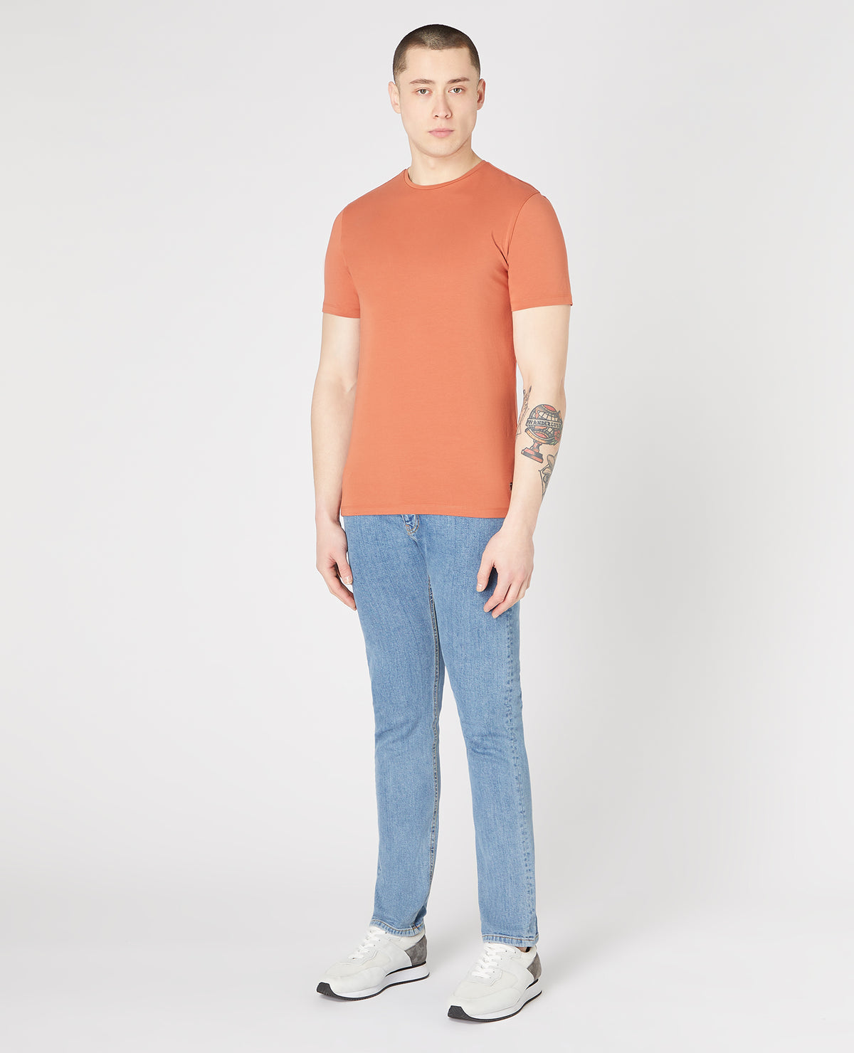 Man wearing a orange Tapered Fit Cotton-Stretch T-Shirt