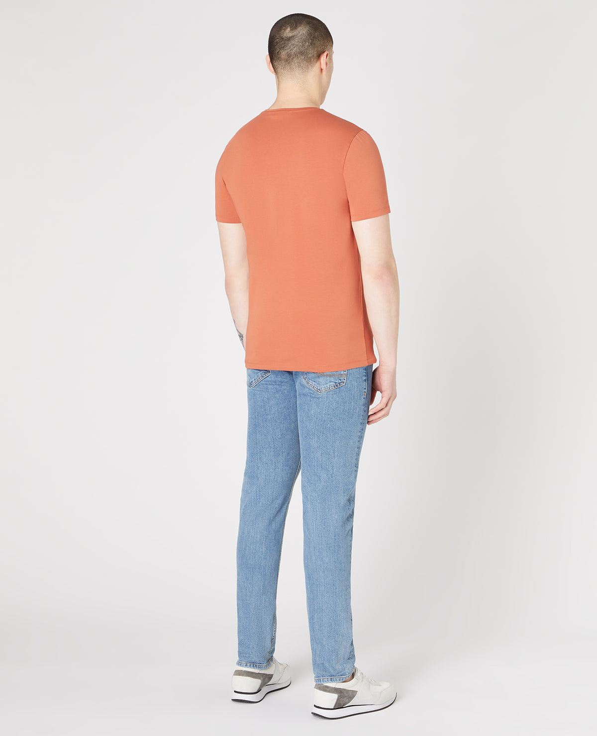 Man wearing a orange Tapered Fit Cotton-Stretch T-Shirt