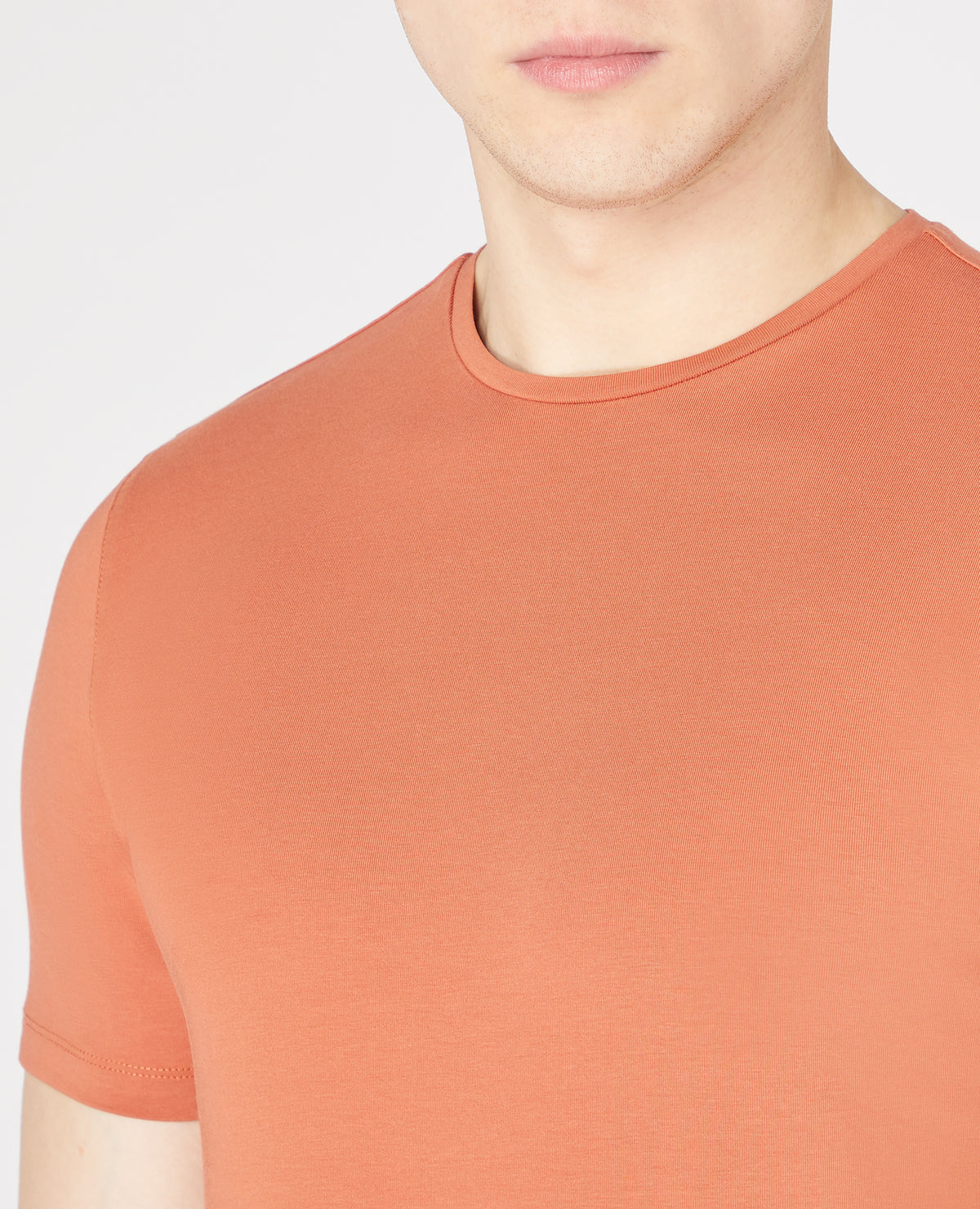 Man wearing a orange Tapered Fit Cotton-Stretch T-Shirt