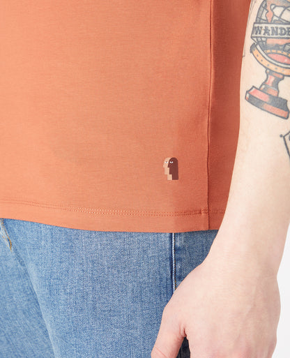 Man wearing a orange Tapered Fit Cotton-Stretch T-Shirt