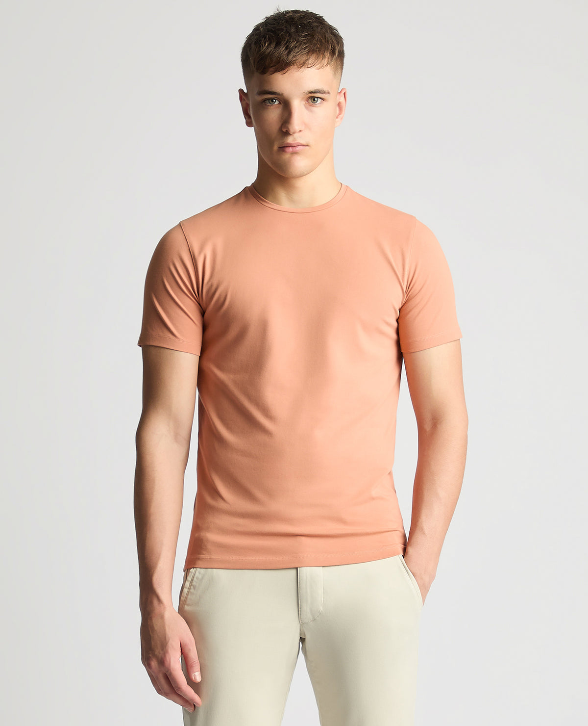 Man wearing a red Tapered Fit Cotton-Stretch T-Shirt