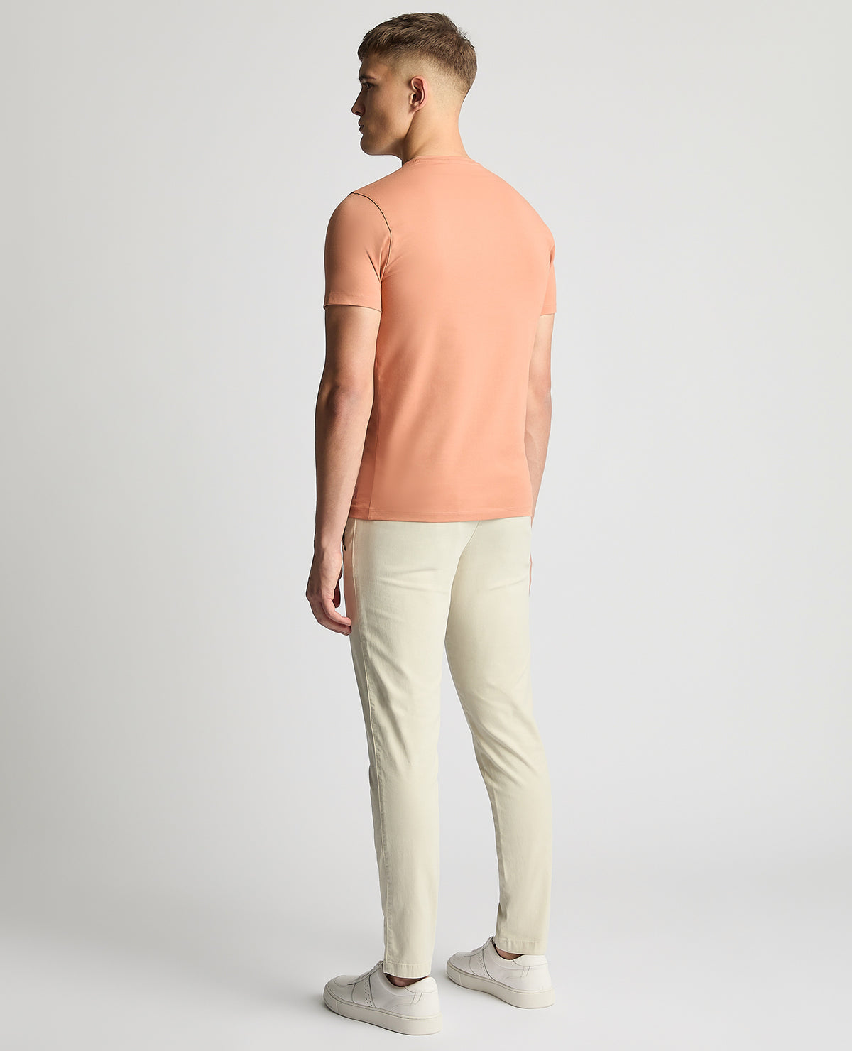 Man wearing a red Tapered Fit Cotton-Stretch T-Shirt