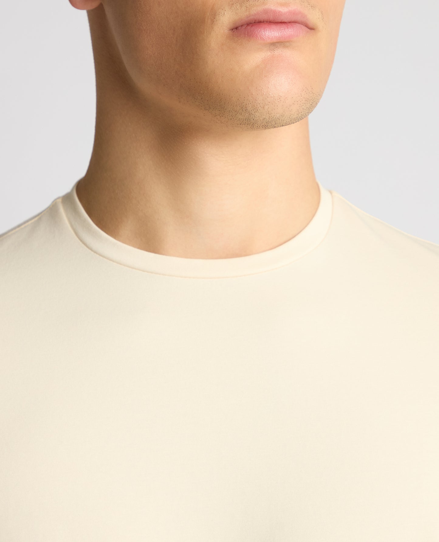 Man wearing a cream t-shirt