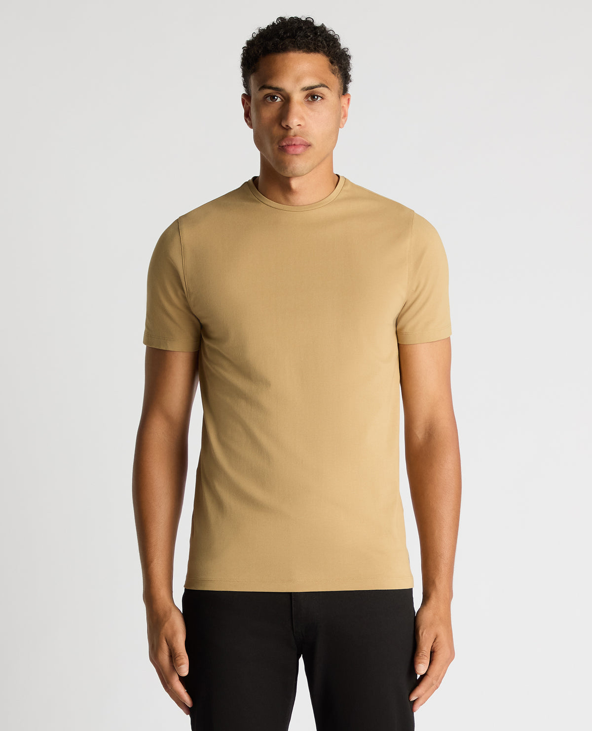 Man wearing a sand Tapered Fit Cotton-Stretch T-Shirt