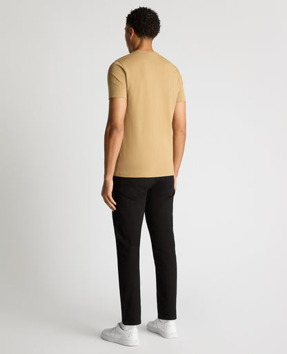 Man wearing a sand Tapered Fit Cotton-Stretch T-Shirt