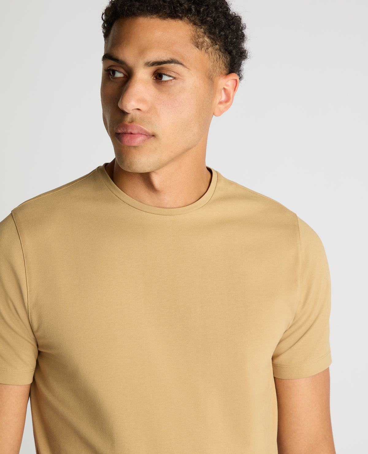 Man wearing a sand Tapered Fit Cotton-Stretch T-Shirt