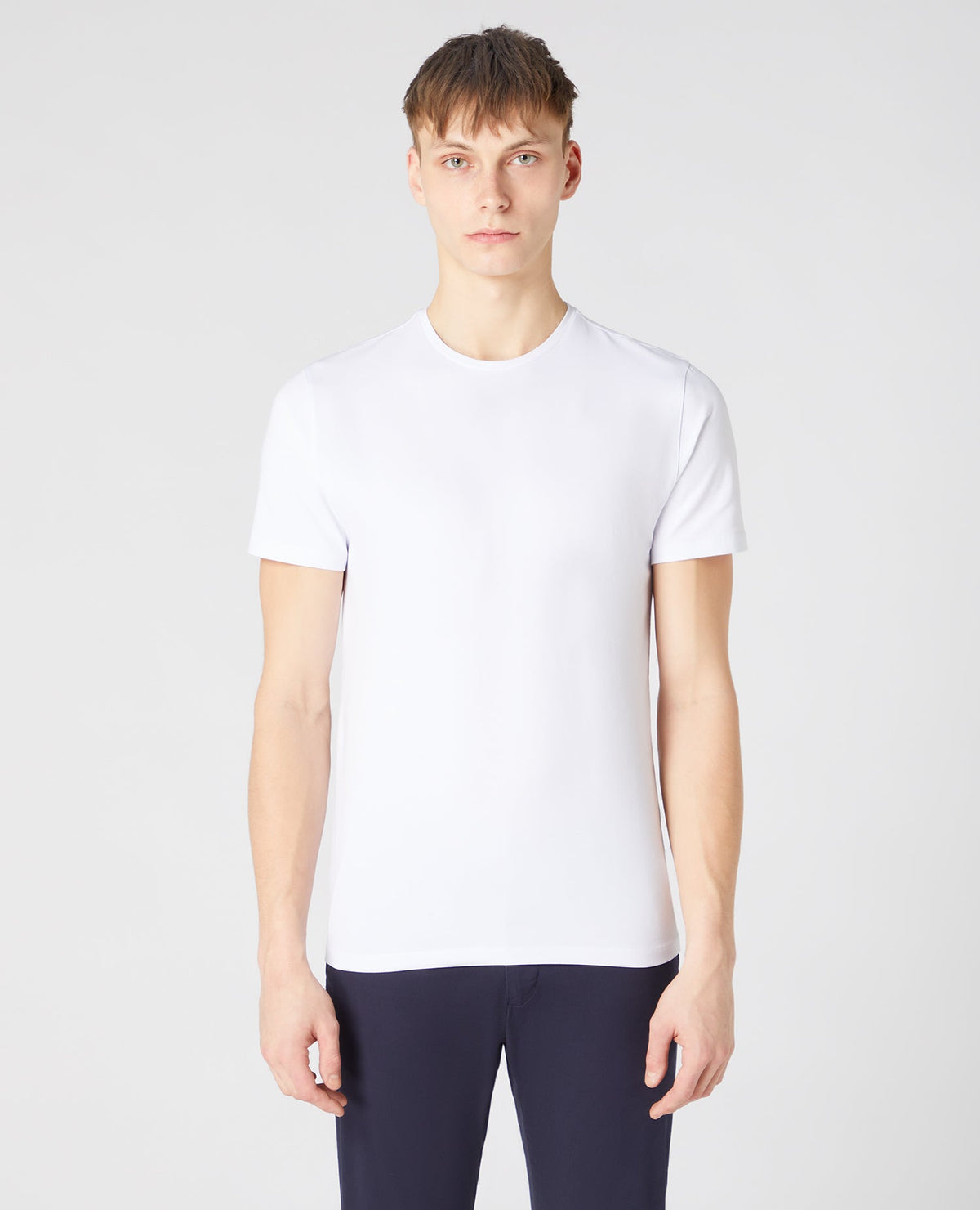 Man wearing a white Tapered Fit Cotton-Stretch T-Shirt