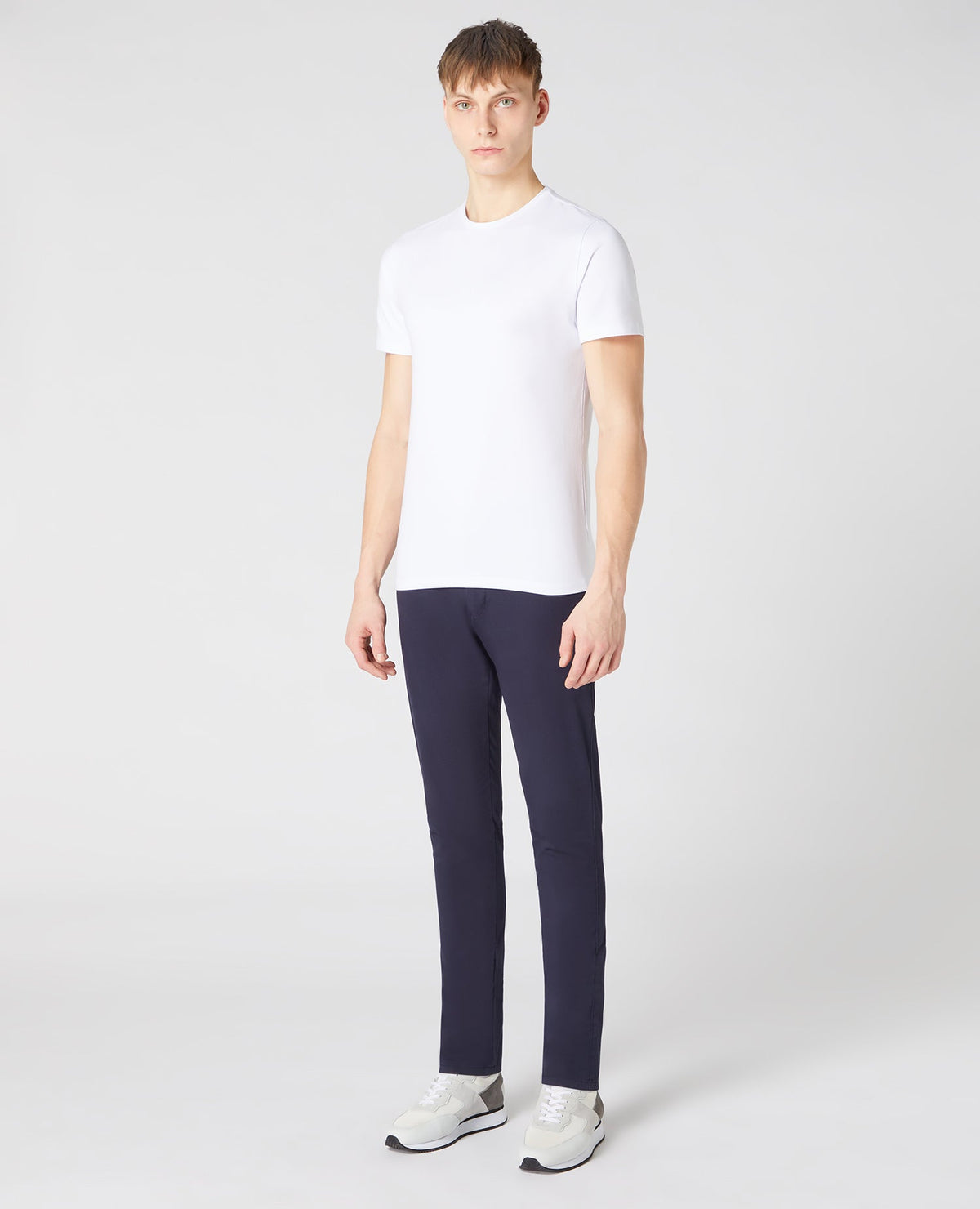 Man wearing a white Tapered Fit Cotton-Stretch T-Shirt