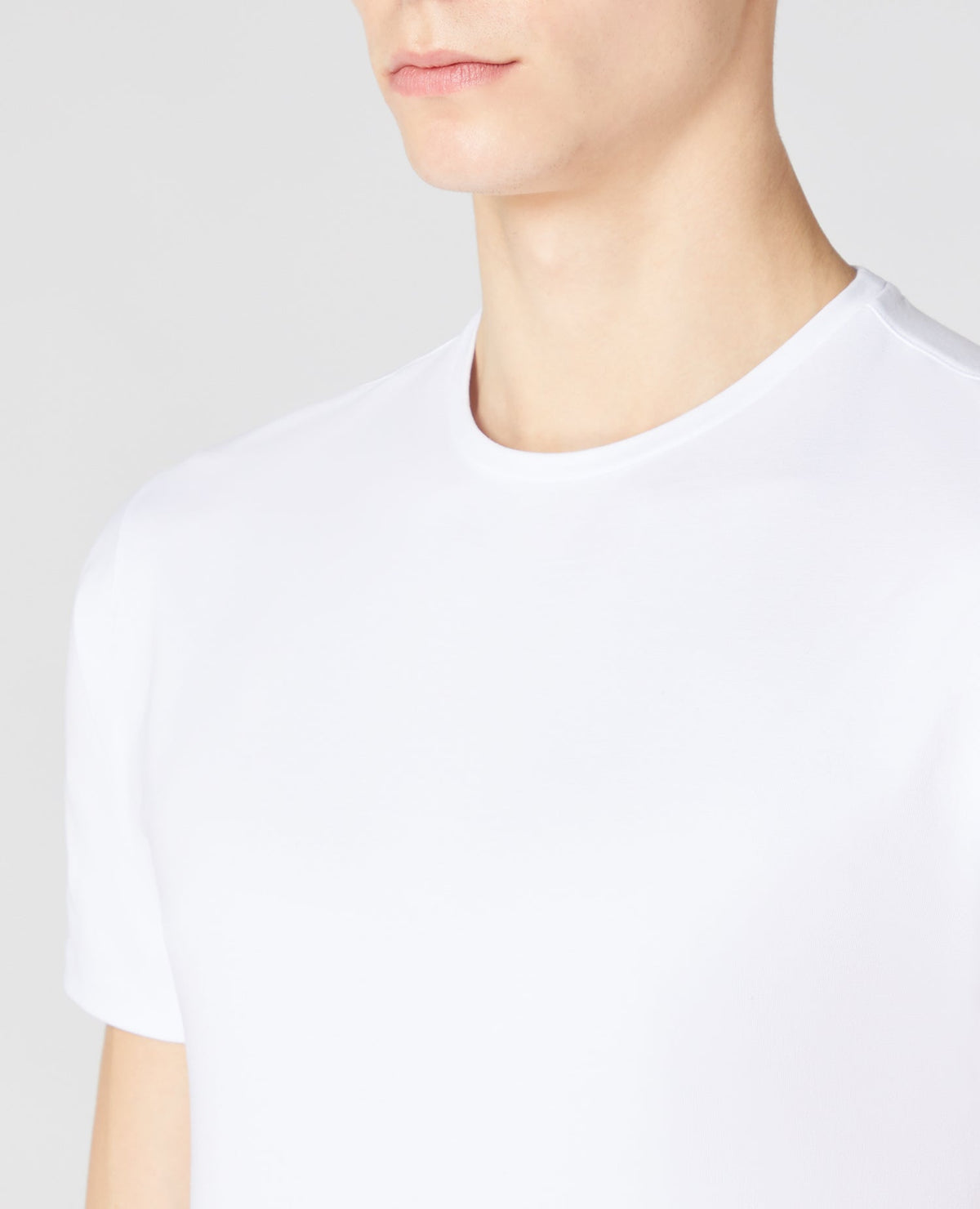 Man wearing a white Tapered Fit Cotton-Stretch T-Shirt