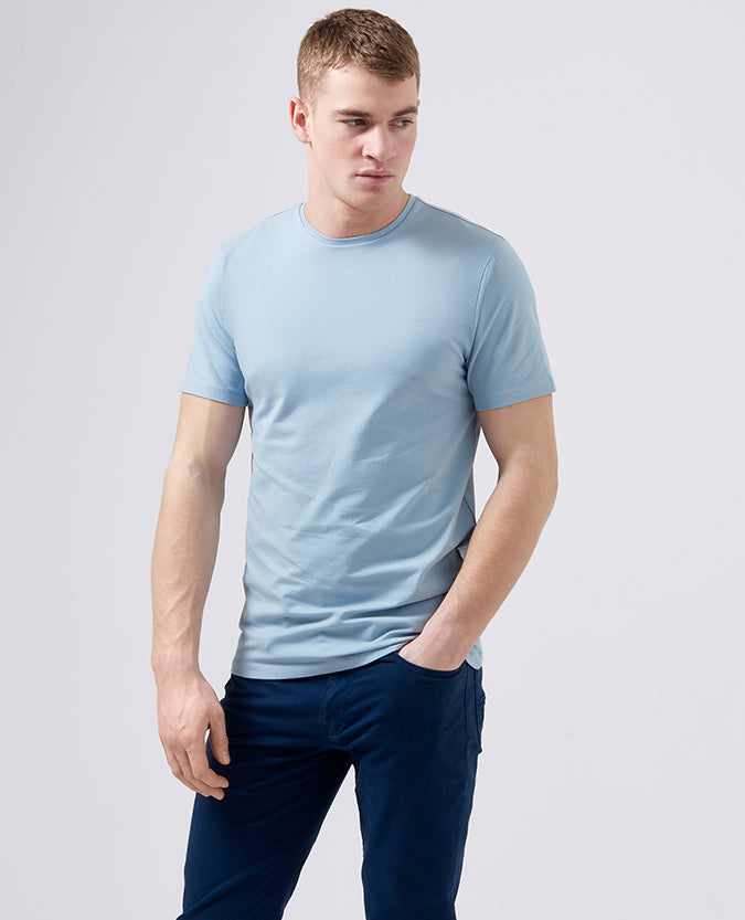 Man wearing a blue Tapered Fit Cotton-Stretch T-Shirt