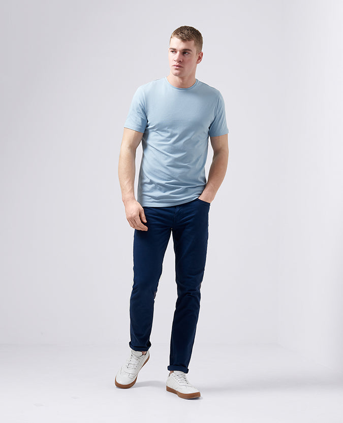 Man wearing a blue Tapered Fit Cotton-Stretch T-Shirt
