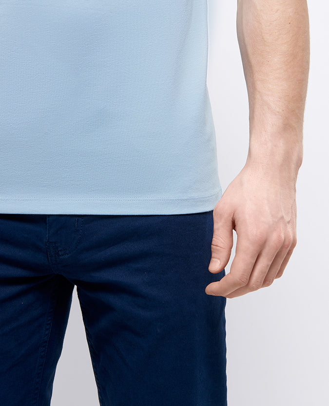 Man wearing a blue Tapered Fit Cotton-Stretch T-Shirt