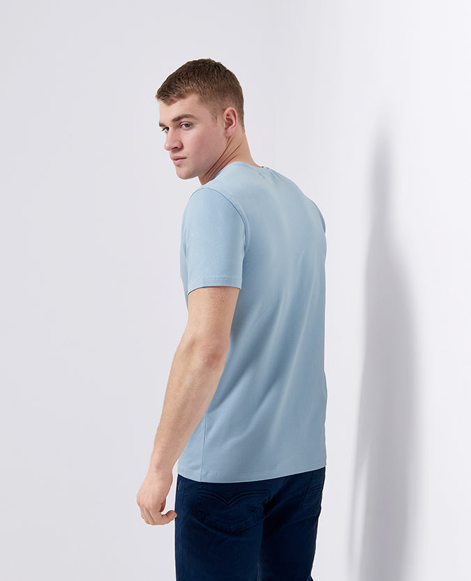 Man wearing a blue Tapered Fit Cotton-Stretch T-Shirt