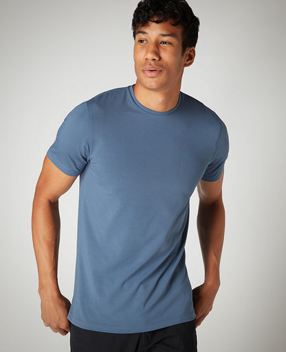Man wearing a blue Tapered Fit Cotton-Stretch T-Shirt