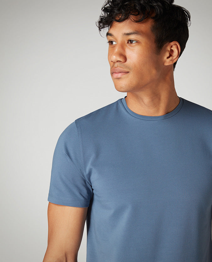 Man wearing a blue Tapered Fit Cotton-Stretch T-Shirt
