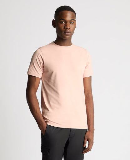 Man wearing a pink Tapered Fit Cotton-Stretch T-Shirt