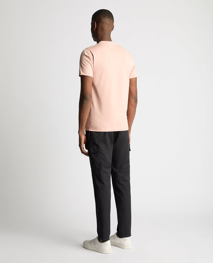 Man wearing a pink Tapered Fit Cotton-Stretch T-Shirt