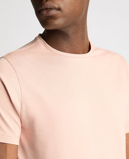Man wearing a pink Tapered Fit Cotton-Stretch T-Shirt