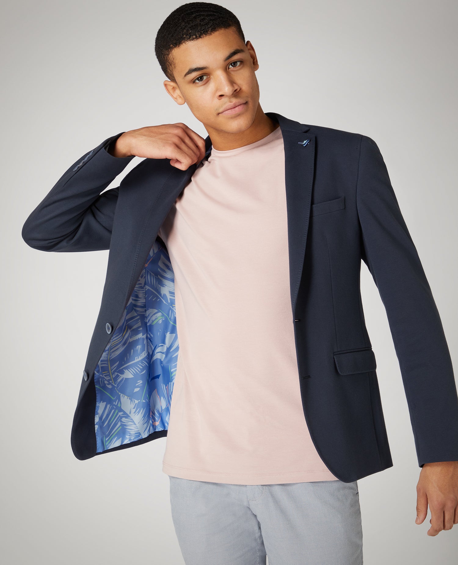 Man wearing a pink Tapered Fit Cotton-Stretch T-Shirt