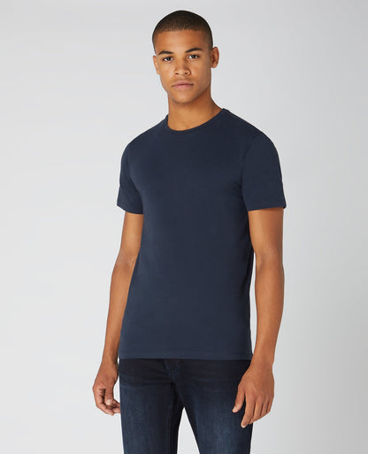 Man wearing a navy Tapered Fit Cotton-Stretch T-Shirt
