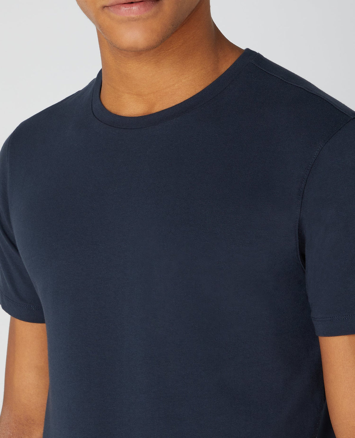 Man wearing a navy Tapered Fit Cotton-Stretch T-Shirt