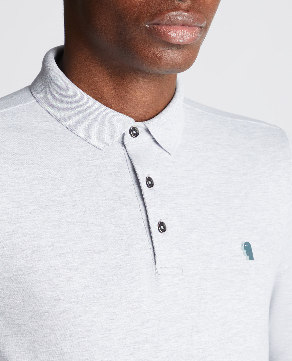 Man wearing a grey Tapered Fit Cotton-Stretch Long-Sleeve Polo Shirt