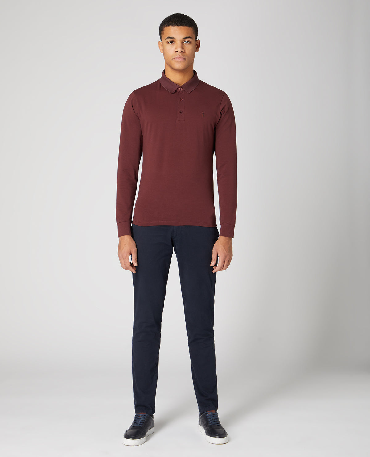 Man wearing a red Tapered Fit Cotton-Stretch Polo Shirt