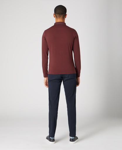 Man wearing a red Tapered Fit Cotton-Stretch Polo Shirt