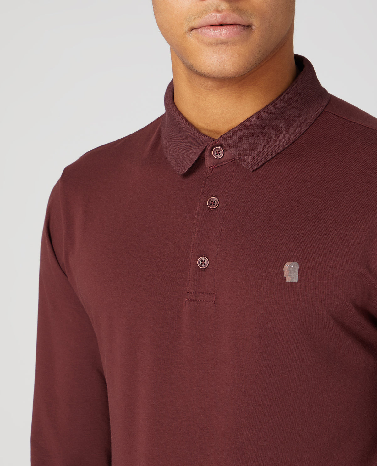 Man wearing a red Tapered Fit Cotton-Stretch Polo Shirt