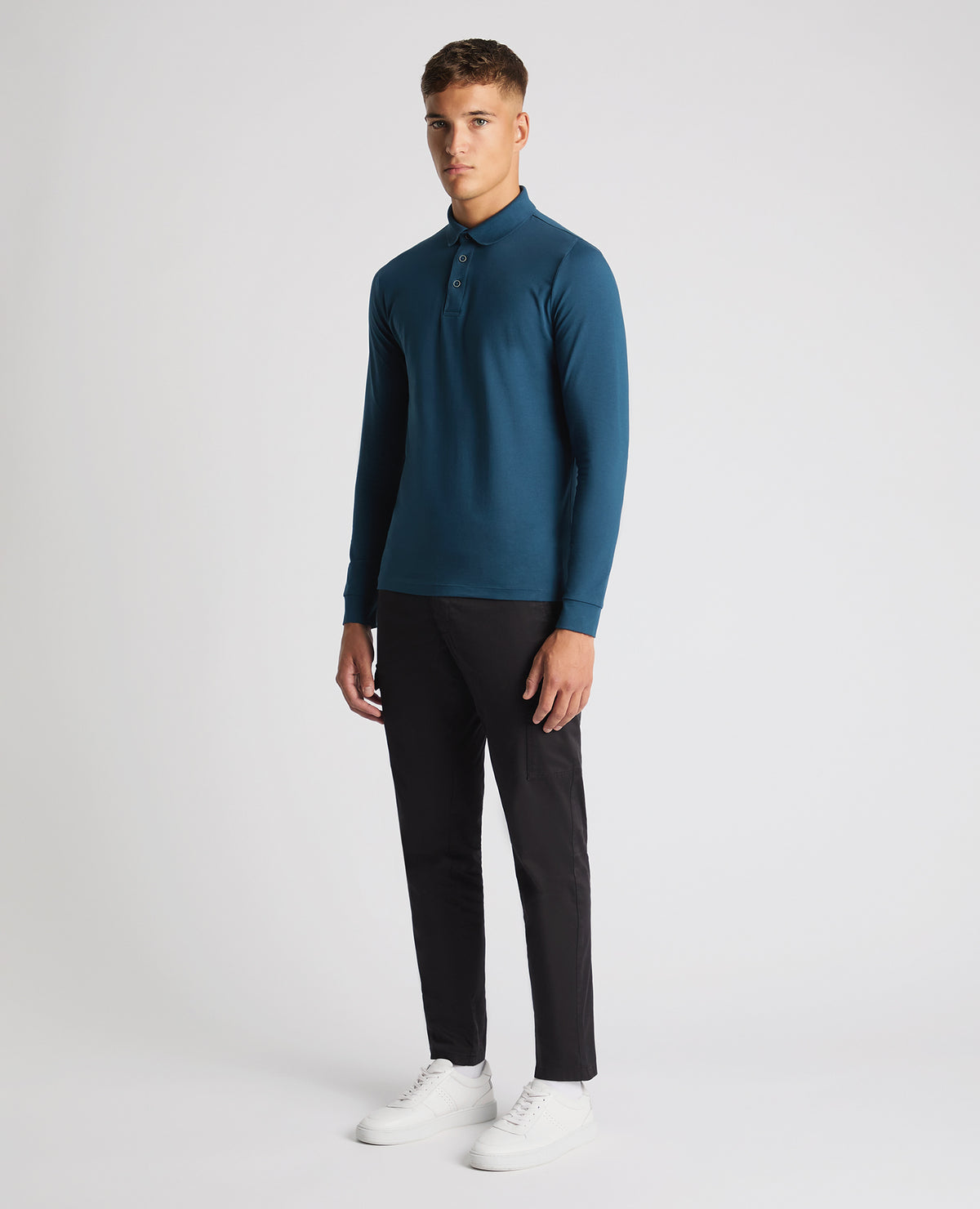 Man wearing a blue Tapered Fit Cotton-Stretch Polo Shirt