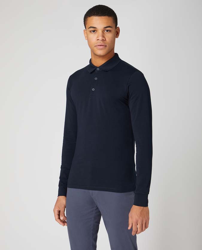Man wearing a navy Tapered Fit Cotton-Stretch Long-Sleeve Polo Shirt