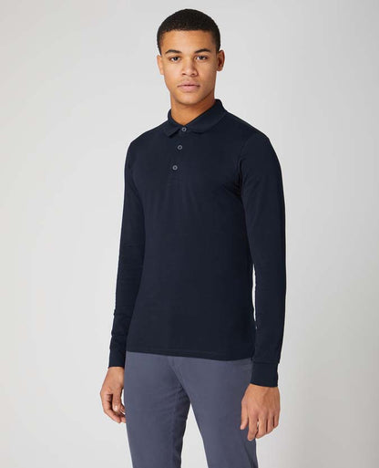 Man wearing a navy Tapered Fit Cotton-Stretch Long-Sleeve Polo Shirt