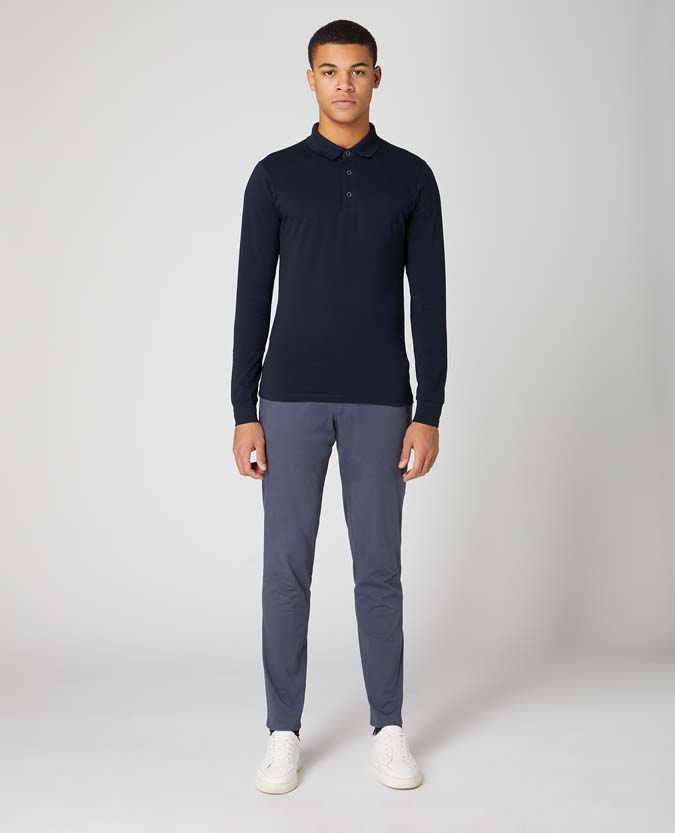 Man wearing a navy Tapered Fit Cotton-Stretch Long-Sleeve Polo Shirt