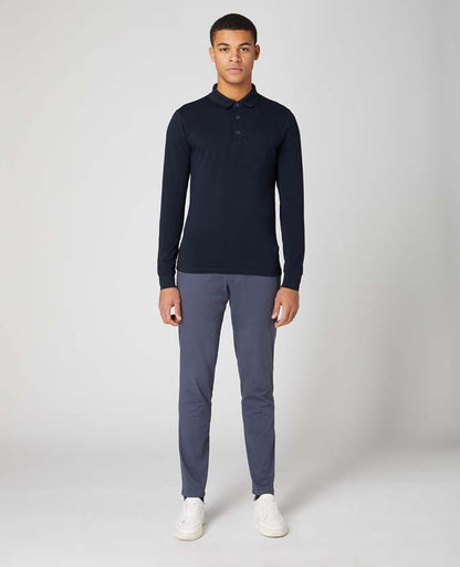 Man wearing a navy Tapered Fit Cotton-Stretch Long-Sleeve Polo Shirt