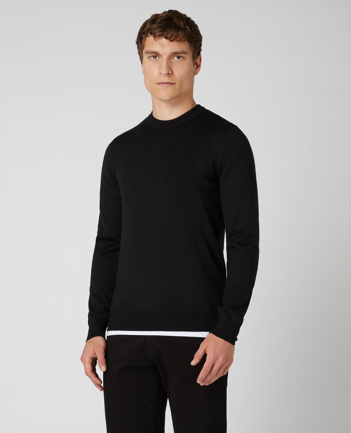 Man wearing a black Tapered Fit Merino Wool-Blend Crew Neck Sweater
