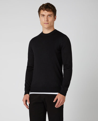 Man wearing a black Tapered Fit Merino Wool-Blend Crew Neck Sweater