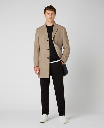 Man wearing a black Tapered Fit Merino Wool-Blend Crew Neck Sweater